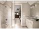 Elegant bathroom with white marble and a luxurious soaking tub, seamlessly connected to the bedroom at 670 Trinity Pl, Suwanee, GA 30024
