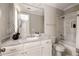 Well-appointed bathroom with marble countertops, a large mirror, and a combined tub and shower at 670 Trinity Pl, Suwanee, GA 30024