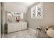 Bright bathroom featuring marble floors, double vanity and a glass-enclosed shower at 670 Trinity Pl, Suwanee, GA 30024