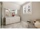 Bright bathroom with marble floors, double sinks, and white cabinets at 670 Trinity Pl, Suwanee, GA 30024