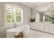 Bright bathroom with a freestanding tub, large windows, and double sink vanity at 670 Trinity Pl, Suwanee, GA 30024