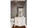 Elegant half bathroom with custom vanity and large mirror at 670 Trinity Pl, Suwanee, GA 30024