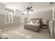 Spacious bedroom featuring neutral walls, plush carpeting, and a stylish tufted headboard at 670 Trinity Pl, Suwanee, GA 30024