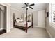 Bright bedroom featuring a four-poster bed and ceiling fan, creating a cozy and inviting space at 670 Trinity Pl, Suwanee, GA 30024