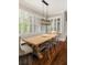 Bright dining area featuring modern chairs, a farmhouse table and large windows at 670 Trinity Pl, Suwanee, GA 30024