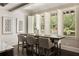 Bright dining area with white wainscoting, wood table, stylish chairs, and large windows offering outdoor views at 670 Trinity Pl, Suwanee, GA 30024