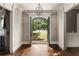 Grand foyer with hardwood floors, arched doorway, and a view of the landscaped front yard at 670 Trinity Pl, Suwanee, GA 30024
