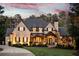 Stunning brick home with a well-manicured lawn, elegant front door, and inviting curb appeal at 670 Trinity Pl, Suwanee, GA 30024