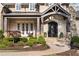 Elegant brick home with stone accents, manicured landscaping, and a welcoming front porch at 670 Trinity Pl, Suwanee, GA 30024
