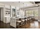 Bright kitchen with a large center island, bar seating, and designer pendant lighting at 670 Trinity Pl, Suwanee, GA 30024