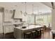 Gourmet kitchen features a large island, stainless steel appliances and marble backsplash at 670 Trinity Pl, Suwanee, GA 30024