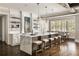 Expansive kitchen featuring marble countertops, a large island with seating, and designer pendant lighting at 670 Trinity Pl, Suwanee, GA 30024