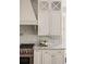 Close-up showcasing the kitchen's sleek countertops, stainless steel appliances, and elegant tile backsplash at 670 Trinity Pl, Suwanee, GA 30024