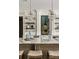 Bright kitchen island with marble countertop, lighting fixtures, and bar stool seating at 670 Trinity Pl, Suwanee, GA 30024