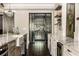 Kitchen with stainless steel appliances, marble countertop, and custom wine cellar nearby at 670 Trinity Pl, Suwanee, GA 30024