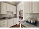 Kitchen nook with custom cabinetry, granite counters, and stainless steel appliances at 670 Trinity Pl, Suwanee, GA 30024