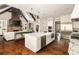 Open kitchen to the living room with large island, stainless appliances, and hardwood floors at 670 Trinity Pl, Suwanee, GA 30024