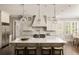 Bright kitchen featuring a large center island with seating, pendant lighting, and professional-grade appliances at 670 Trinity Pl, Suwanee, GA 30024