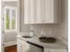 Cozy kitchenette featuring granite countertops, stainless steel sink, and custom cabinetry at 670 Trinity Pl, Suwanee, GA 30024