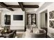 Inviting living room featuring wood beam ceiling, comfortable seating and a built-in entertainment center at 670 Trinity Pl, Suwanee, GA 30024