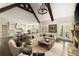 Open-concept living room with exposed beams, hardwood floors, and access to the backyard at 670 Trinity Pl, Suwanee, GA 30024
