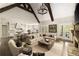 Open-concept living area with exposed beams, a fireplace, and seamless flow to the kitchen at 670 Trinity Pl, Suwanee, GA 30024