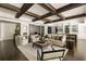Inviting living room with hardwood floors, exposed beams, and stylish neutral furniture at 670 Trinity Pl, Suwanee, GA 30024