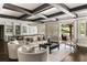Spacious living room with exposed beams, an open floorplan, and access to an outdoor living space at 670 Trinity Pl, Suwanee, GA 30024