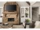 Inviting living room with a stone fireplace, built-in shelving, and comfortable seating for relaxation at 670 Trinity Pl, Suwanee, GA 30024