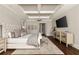 This main bedroom has a decorative ceiling, a chandelier, and an upholstered headboard and bench at 670 Trinity Pl, Suwanee, GA 30024