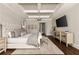 Spacious main bedroom with coffered ceiling, chandelier, and upholstered headboard at 670 Trinity Pl, Suwanee, GA 30024