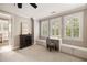 Office space with built-in desk, window shutters, and a comfortable chair at 670 Trinity Pl, Suwanee, GA 30024