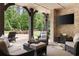 Beautiful backyard with a covered patio, a built-in TV, and ample seating for outdoor entertainment at 670 Trinity Pl, Suwanee, GA 30024