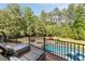 Relaxing poolside lounge area with chaise lounges and a view of the serene backyard at 670 Trinity Pl, Suwanee, GA 30024