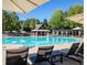 A sparkling community pool with lounge chairs, umbrellas, and a cabana for relaxation at 670 Trinity Pl, Suwanee, GA 30024
