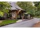 Charming stone pool house with a slate roof and manicured landscaping at 670 Trinity Pl, Suwanee, GA 30024