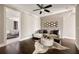 Cozy sitting room featuring hardwood floors, soft ottoman and a decorative patterned wall hanging at 670 Trinity Pl, Suwanee, GA 30024