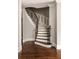 Elegant curved staircase featuring dark wood treads and decorative iron railings at 670 Trinity Pl, Suwanee, GA 30024