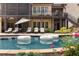 Backyard swimming pool, lounge chairs, and well-manicured landscaping creating a relaxing outdoor oasis at 670 Trinity Pl, Suwanee, GA 30024
