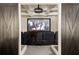 Home theater with dark wood barn doors, projector, and comfortable seating for an immersive experience at 670 Trinity Pl, Suwanee, GA 30024