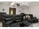 Spacious home theater with reclining leather seats, projector, and cozy atmosphere at 670 Trinity Pl, Suwanee, GA 30024
