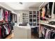 This large walk-in closet features shelving, hanging rods, and a center island at 670 Trinity Pl, Suwanee, GA 30024