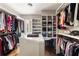 Large walk-in closet featuring custom shelving, hanging racks, and ample storage space at 670 Trinity Pl, Suwanee, GA 30024