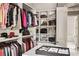 Well-organized walk-in closet featuring custom shelving, racks, and storage for accessories at 670 Trinity Pl, Suwanee, GA 30024