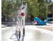 A playful water park area with slides, spray features, and a whale themed structure for  at 670 Trinity Pl, Suwanee, GA 30024