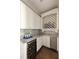 Butler's pantry with wine fridge, custom cabinets, and wine storage at 670 Trinity Pl, Suwanee, GA 30024