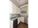 Stylish wine cellar featuring custom storage, marble countertops and a beverage fridge at 670 Trinity Pl, Suwanee, GA 30024
