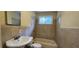 Tile bathroom featuring a sink, toilet, tub, shower, and a window for natural light at 1162 Sims St, Atlanta, GA 30310