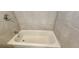 Close-up of the bathtub in the bathroom with tiled walls at 1162 Sims St, Atlanta, GA 30310