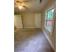 Bright bedroom featuring carpeted floors, two doors, and a window offering plenty of natural light at 1162 Sims St, Atlanta, GA 30310